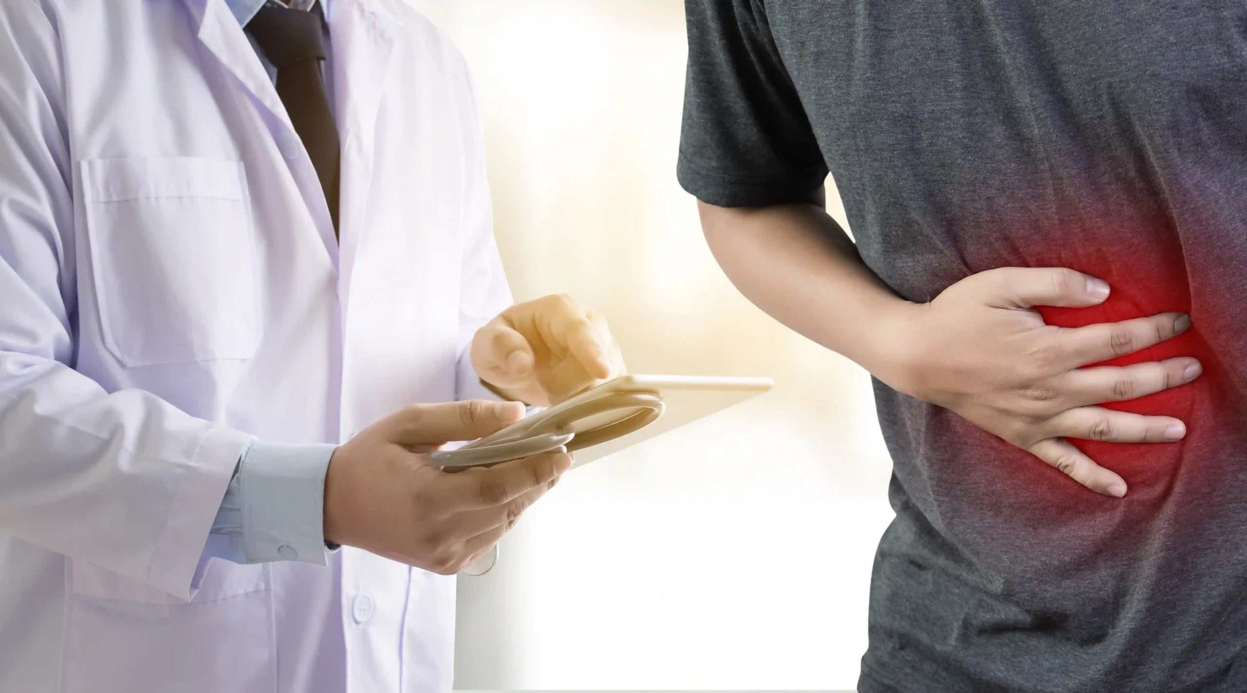 A man suffering from chronic pancreatitis seeking treatment from a doctor.
